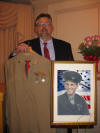 Wilfred O. Hansen Jr proudly shown with his fathers uniform. 